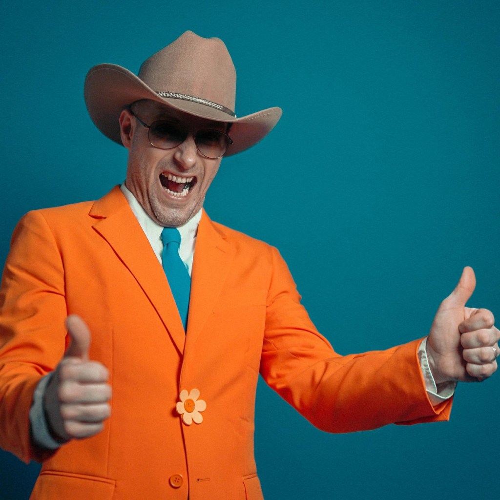 Man, German, Hat, Shades, Blue, Teal, Aqua, Tie, Suit, Orange, Brown, Peach, Flower, Button, Blazer, Musician, Artist, Singer