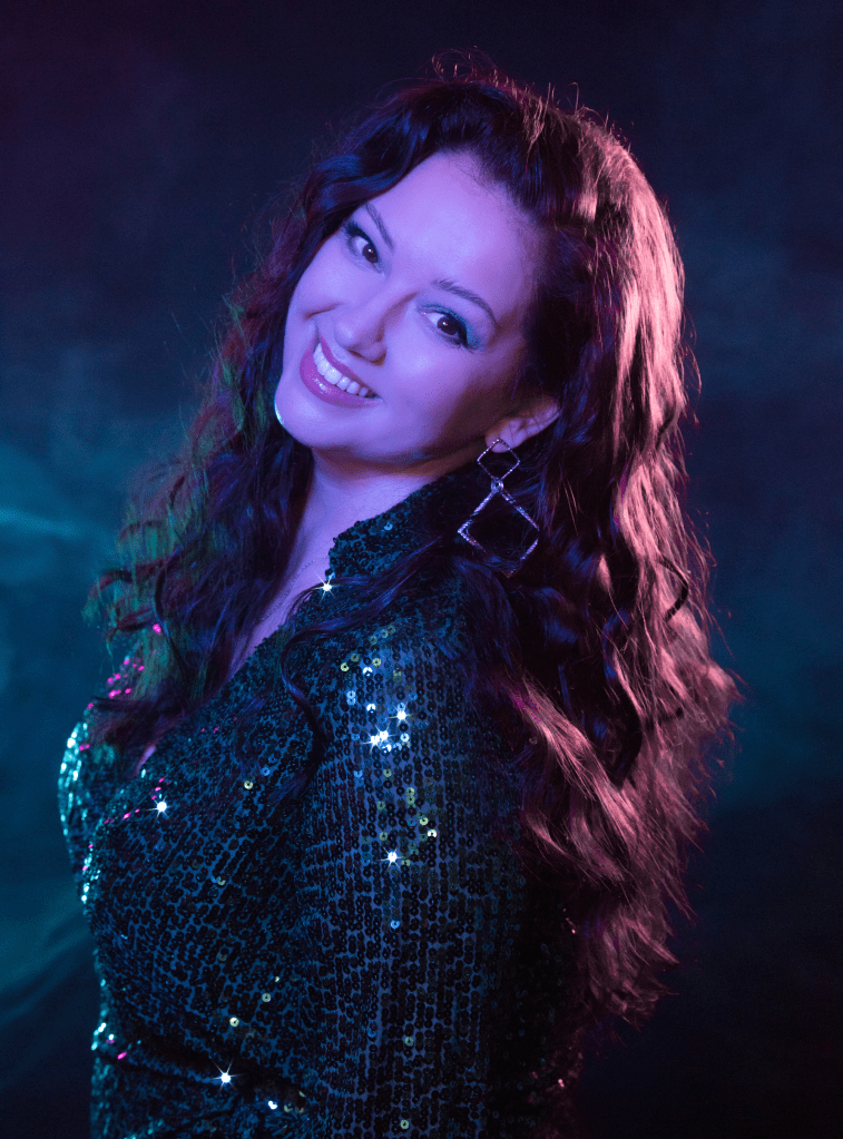 Woman, Lighting, Blue, Purple. Sunsparks, Amanda Wilson, Pink, Purple, Shiny, Shirt, Hair, Music, Song, Musician, Artist, Band, Spotify, Artist