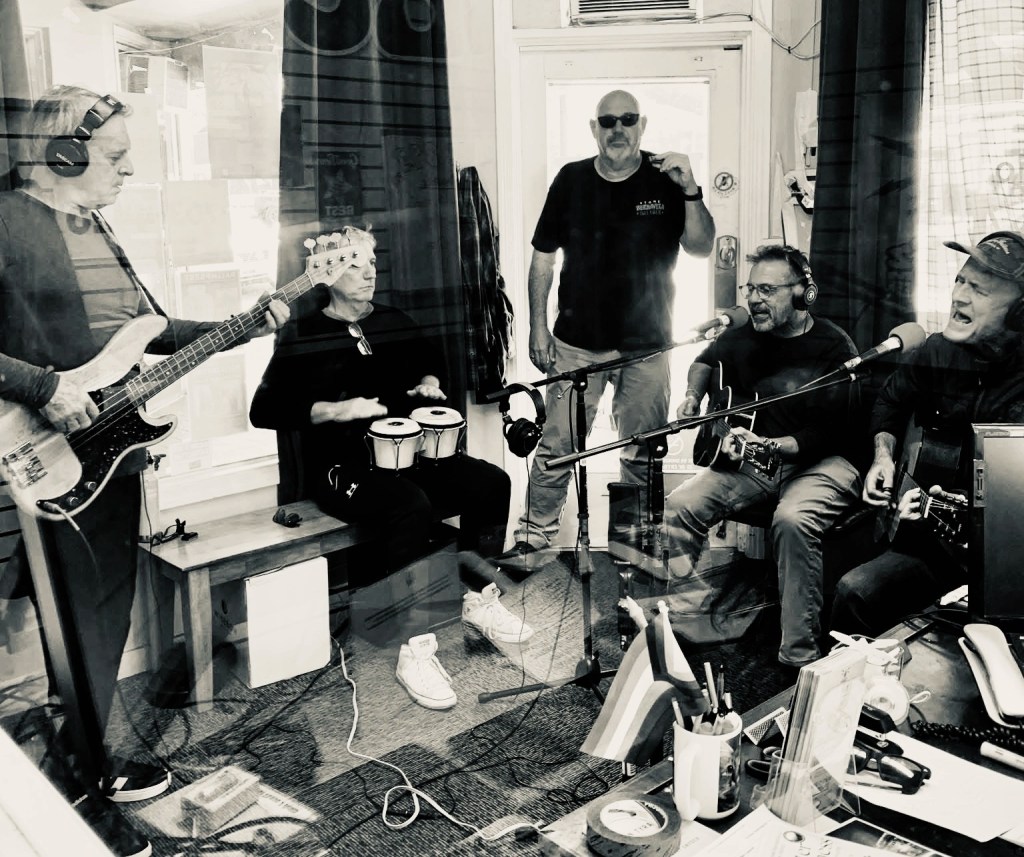 Men, Band, Sepia, Black, White, Monochrome, Jeans, Shoes, Desk, Laptop, Singer, Musician, Drummer, Bassist, Guitars, Mic, Stand, Curtains, Window, Shoes, Table, Chair, Seat, Monitor, Equipment