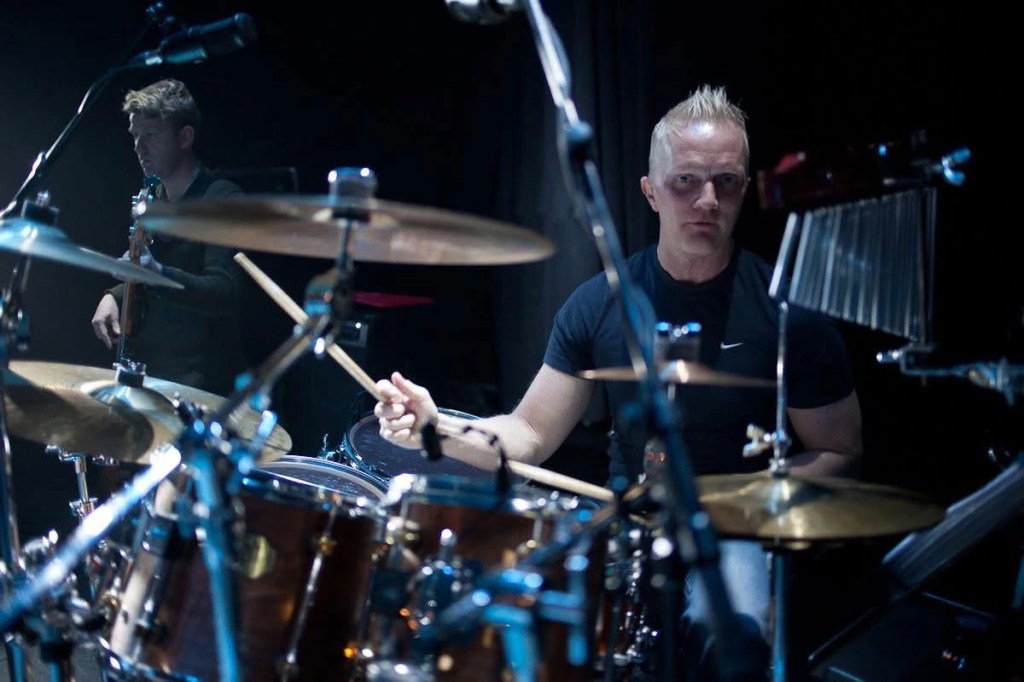 Rock, Drums, Catholic, Icelandic, Nordic, Black, Tshirt. Stick, Cymbal, Music, Song, Artist, Singer, Gospel, Classic, Blonde, Mic, Band