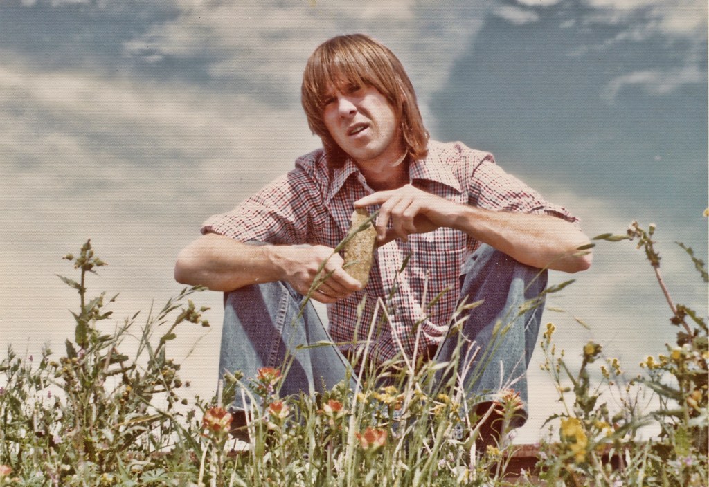 Man, Sky, Blue, Grass, Flower, Man, Bowl Cut, Brunette,, Red, Shirt, Jeans, Blue, Musician, Artist, Singer, Rock