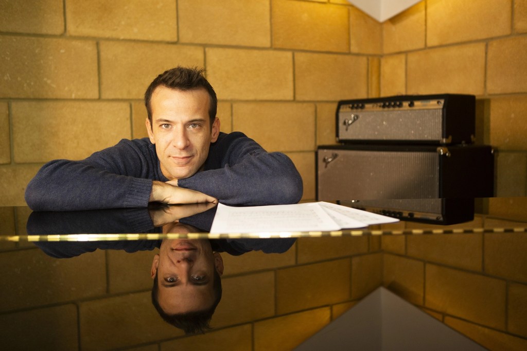 Music, Musician, Artist, Singer, UK, Italian, Milan, London, England, Yellow, Wall, Brick Wall, Sweatshirt, Piano, Keys, Speakers, Yellow, Marshall, Radio, Reflection, Papers, Mirror