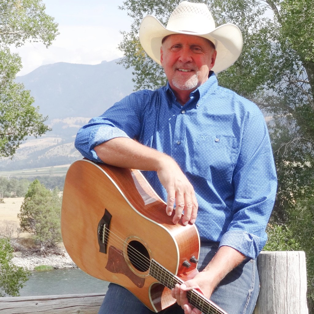 Man, Hat, Country, Music, Song, Musician, Guitar, Acoustic, Brown, Shirt, Green, Trees, Strumming, Picture, Sun, Texas, Lonely, Blue, Shirt, Pants, Jeans, Sky, Cloud